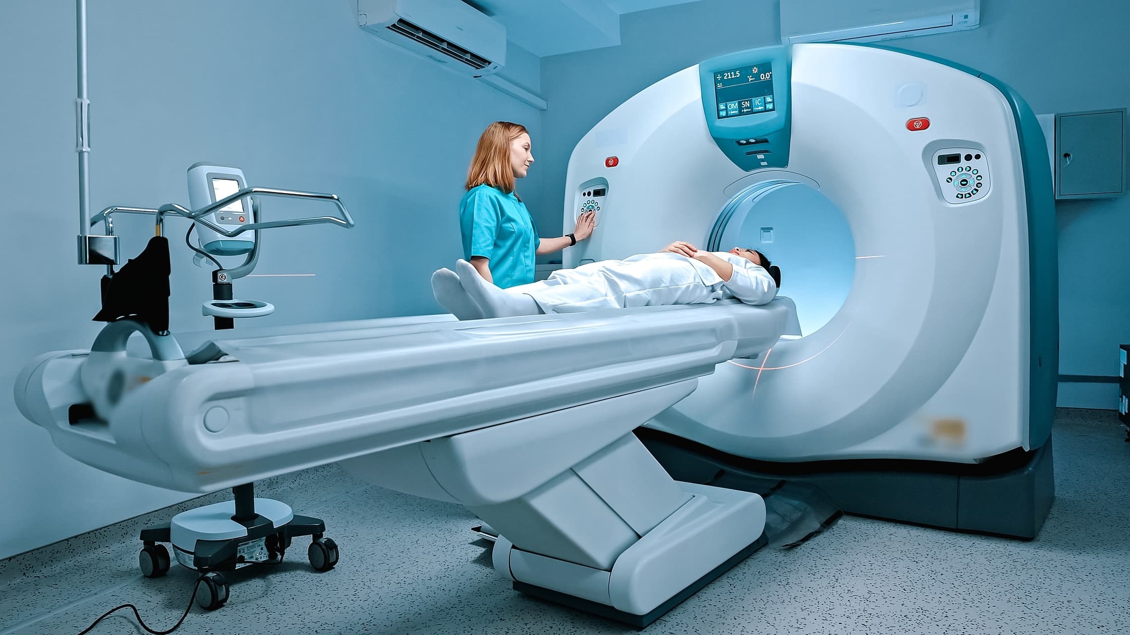 A doctor puts a patient into an MRI machine