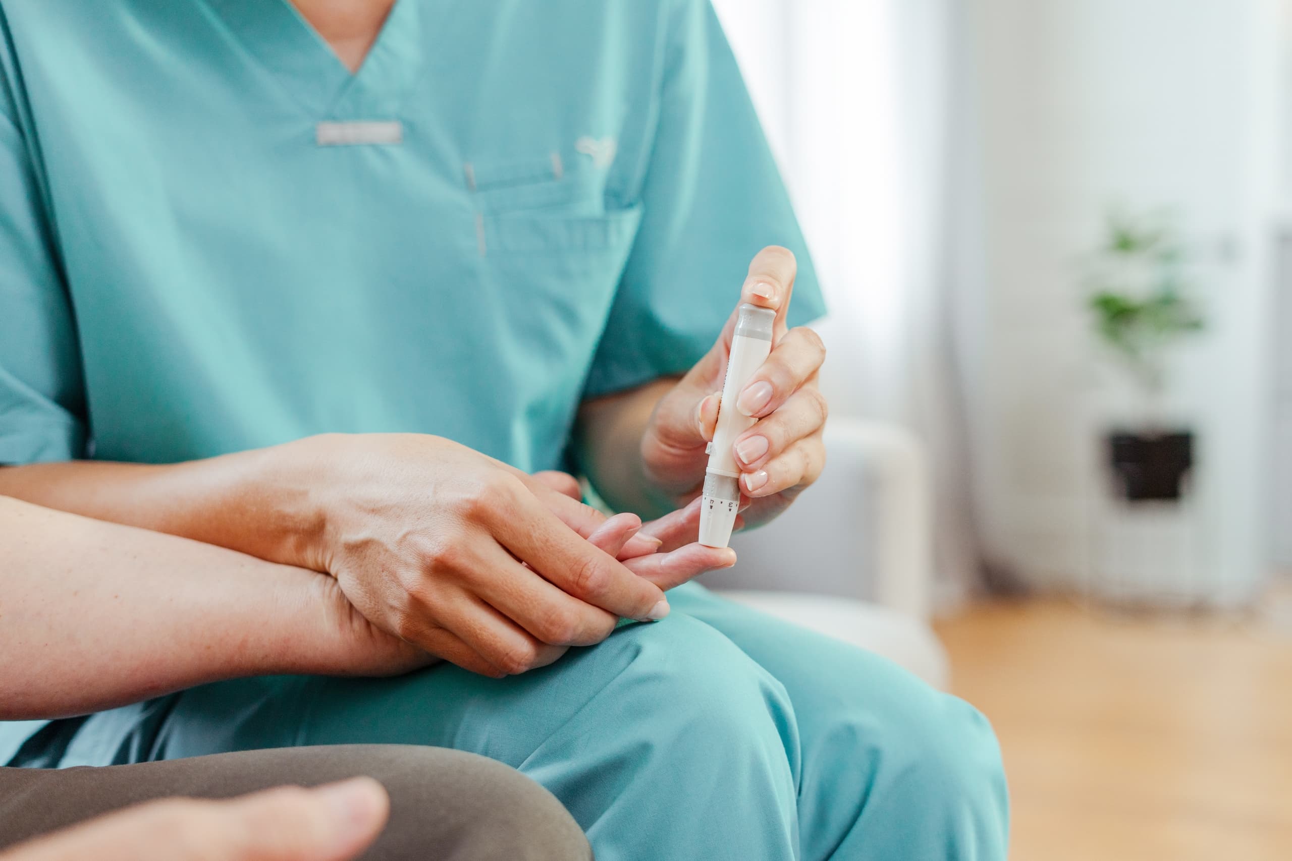 A medical professional tests a patient's blood sugar