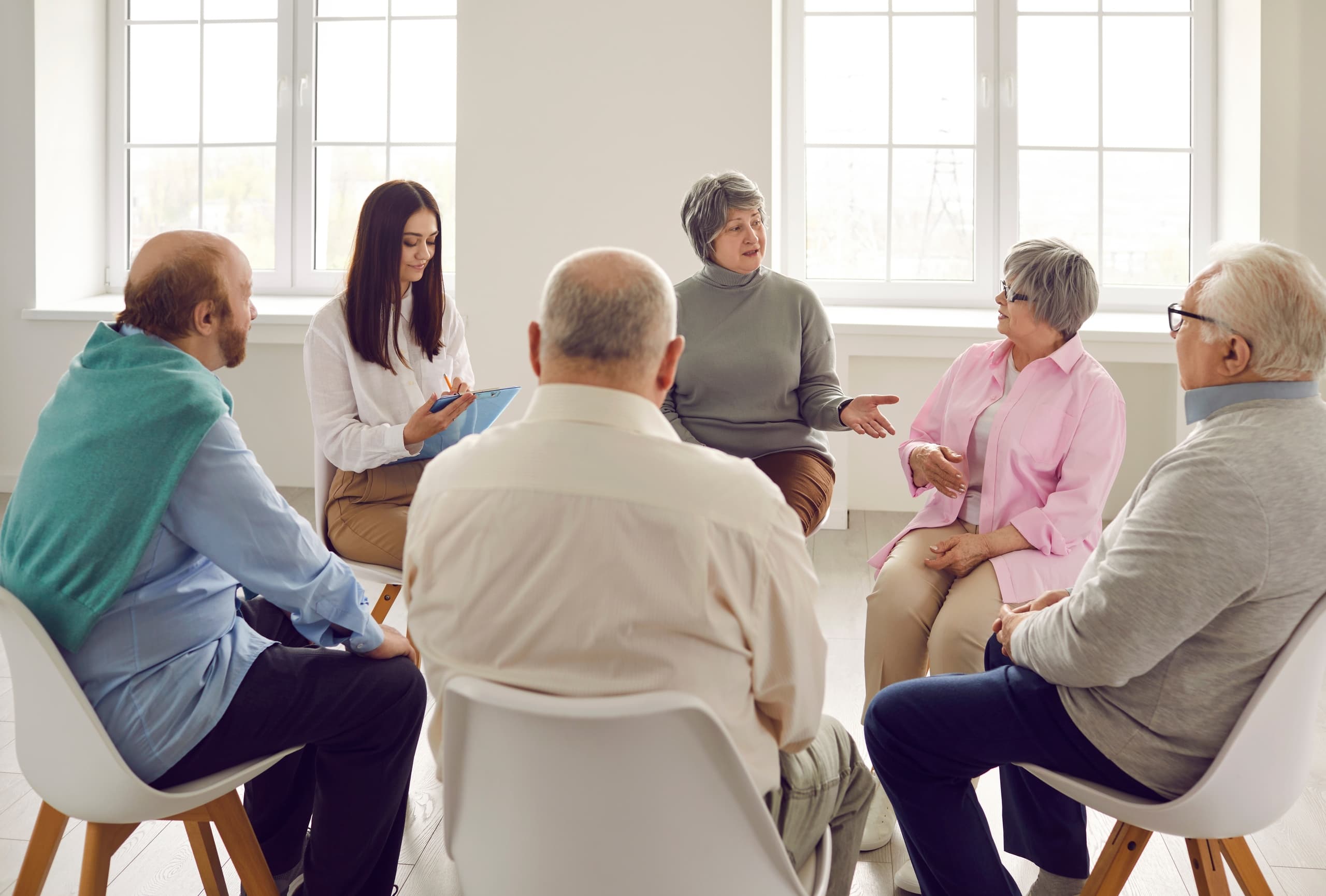 A group of people sit in a circle talking