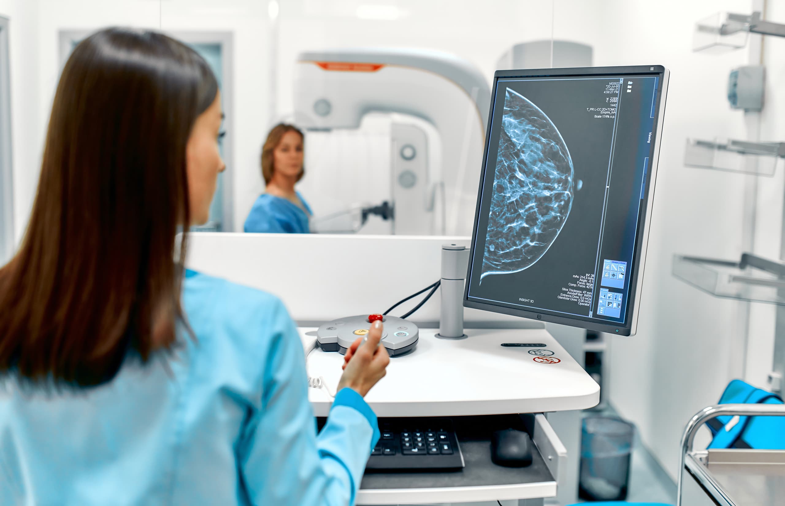 A medical professional reviews a mammogram X-Ray